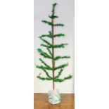 An early 20th Century artificial christmas tree, table standing, purchased from the store Woolworths