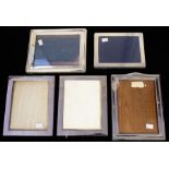 A collection of four George V silver mounted plain rectangular frames, wooden easel backed, three