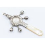 **REOFFER JANUARY A&C £20-30**  A Victorian silver child's combined rattle/whistle/teether, embossed