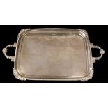 A George V silver large two handled tray, gadroon border with scrolling foliate handles, the