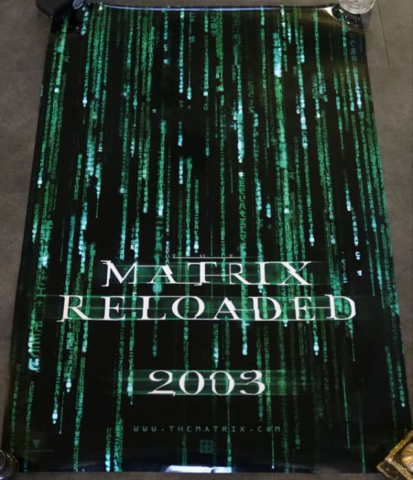 A collection of vintage movie posters 'The Matrix' (1999), 'Matrix Reloaded' (2003), 'The Matrix - Image 2 of 3