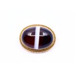 A large gold mounted polished agate brooch with large banded cabochon with beaded gold border, 17.8g