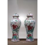 PAIR OF FAMILLE ROSE LIDDED VASES