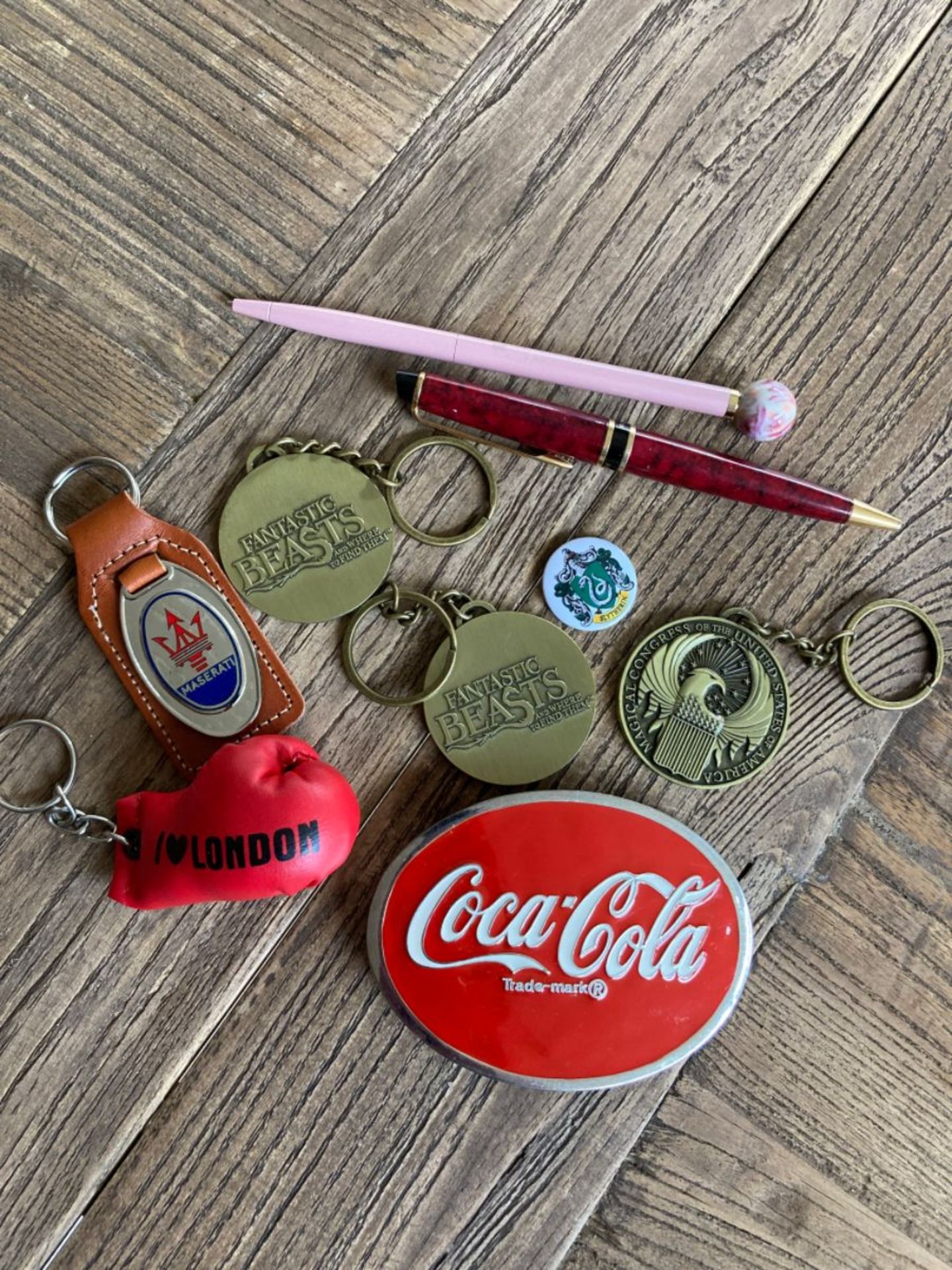 MIXED ITEMS INC COCA COLA BUCKLE, KEYRINGS, PENS ETC