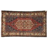Persian rug, Mazlogan Red ground, decorated with a tobacco-yellow rhombus covered in flowers, blue