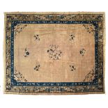 Rug CHINA Tobacco-brown ground, decorated with a blue medallion containing a plum tree, in a bed