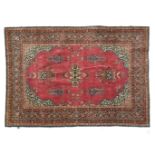 Keshan rug Red ground, decorated with a medallion between mosque lamps, blue spandrels, blue