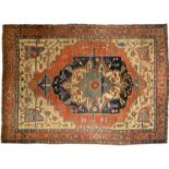 Heriz rug 19TH CENTURY Red ground, blue floral medallion, cream-coloured spandrels with Shah Abbas