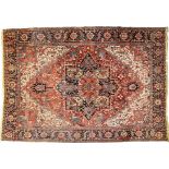 Heriz rug Red ground covered in flowering stems, large, blue floral medallion, cream-coloured