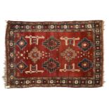 Prerepredil prayer rug, Caucasus, red ground, decorated with cross-shaped medallions and daggers,