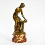 Vintage woman doing her toilette 20TH CENTURY WORK Bronze sculpture with golden patina. Red marble