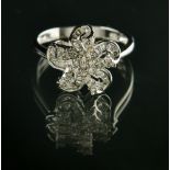 Flower ring 18 kt white gold, set with brilliants and diamond baguettes for an approx. total of 0.80
