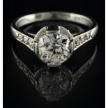 Solitaire ring Platinum, set with an antique-cut diamond of approx. 1.15 ct, flanked by eight