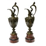 Large pair of ewers 19TH CENTURY WORK Bronze with brown patina, on cherry-red and black marble base.