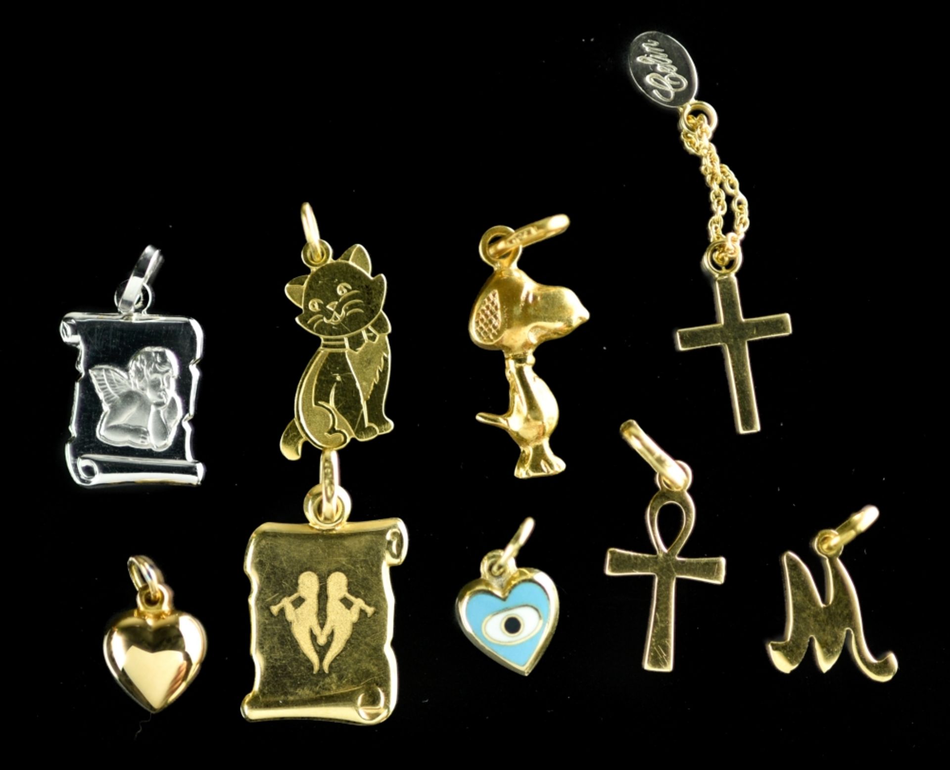 Lot of nine pendants or charms 18 kt gold (8 pendants: 7.8 gr) or 15 kt gold (1 pendant: 0.6 gr).