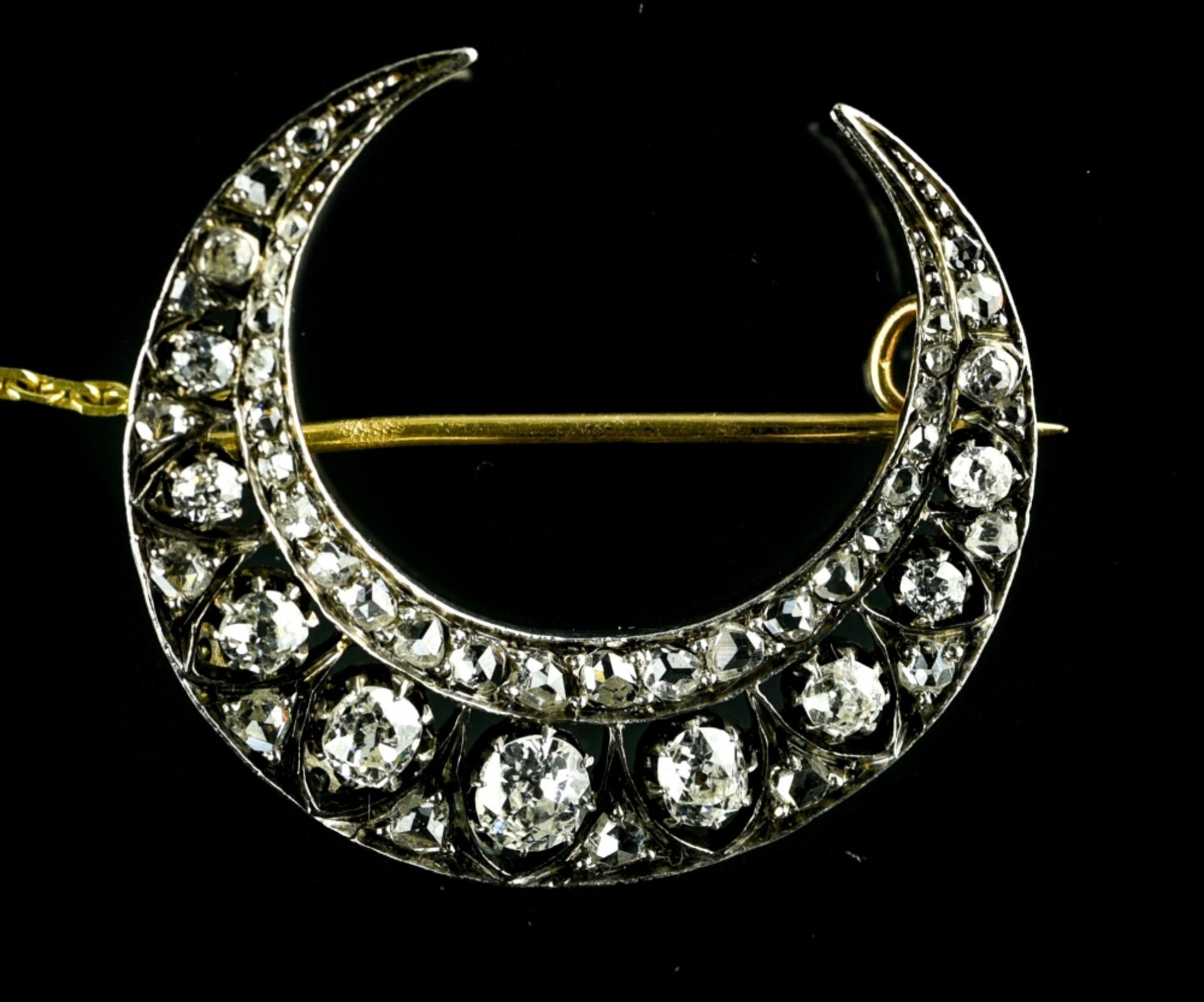 Crescent moon brooch White gold on 18 kt rose gold, set with eleven antique-cut diamonds, with an