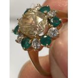 Jewellery: Thirteen stone cluster ring. Central oval faceted pale yellow stone (valued as