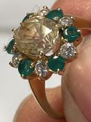 Jewellery: Thirteen stone cluster ring. Central oval faceted pale yellow stone (valued as