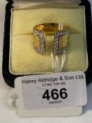 Jewellery: Yellow metal tapering ring with split head set with forty two brilliant cut diamonds,