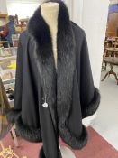 Fashion: Black cashmere long evening cape with black fur trim, label reads Made in Great Britain,