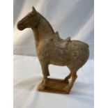 Archaic Chinese: Terracotta figure of a horse in a bespoke perspex case with label 'Tang Dynasty