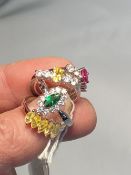 Costume Jewellery: White metal rings, four set with coloured and white synthetic stones. Total