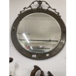 19th cent. Circular bevelled mirror with pressed brass frame surmounted by ribbon swags with tin