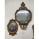 19th cent. Octagonal mirror in a Rococo style bronzed frame, 36ins. x 21ins. Plus a smaller over