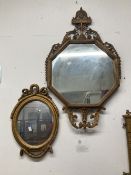 19th cent. Octagonal mirror in a Rococo style bronzed frame, 36ins. x 21ins. Plus a smaller over