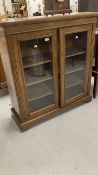 19th cent. Oak short bookcase, glazed doors on bracket base.