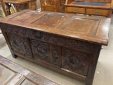 18th cent. oak coffer with carved decoration to front, the top opening in two sections. 52ins. x