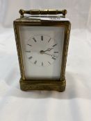 20th cent. Brass carriage clock, white enamel face, decorated with floral engraving and traces of