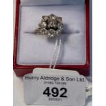 Jewellery: White metal nine stone open cluster claw set with nine brilliant cut diamonds,