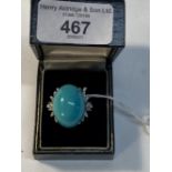 Jewellery: White metal ring set with an oval turquoise 25mm x 20mm and thirty brilliant cut