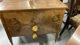 20th cent. German birds eye maple chest of two drawers, on tapering supports.