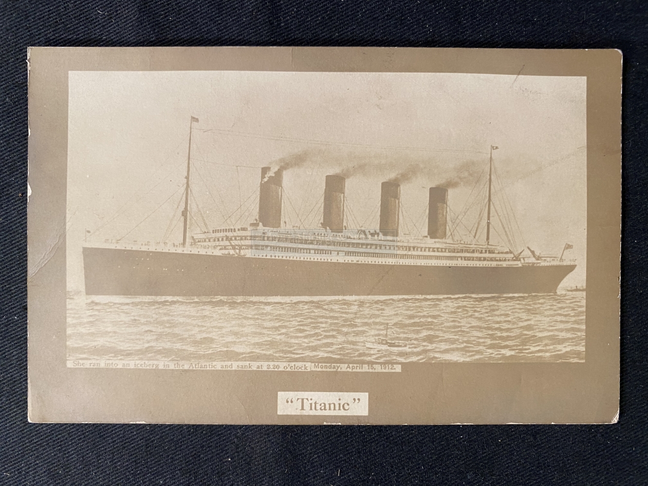 R.M.S. TITANIC: Rare post-disaster privately printed postcard of Titanic at sea.