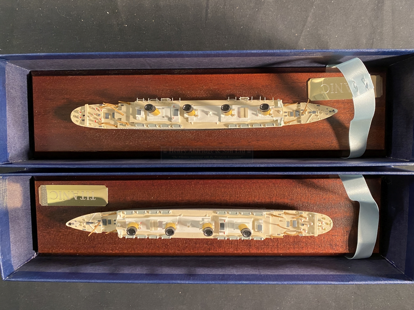 R.M.S. TITANIC: Boxed pair of modern Mercator cast models, on treen stands. 11½ins.