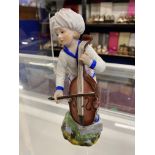 Ceramics: Hochst figure of a man standing with a cello, in white coat and pale yellow breeches,