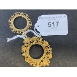 Coin mounts yellow metal test as 9ct ornate floral decoration, plus one other. 14g.