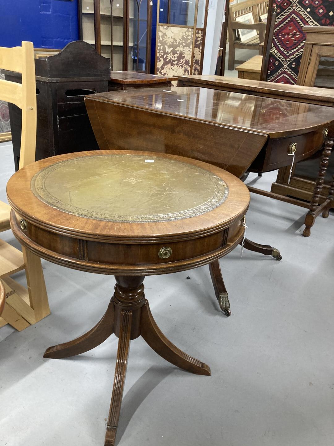 20th cent. Mahogany oval drop leaf table, two drawers beneath and quad supports with brass