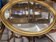 Mirrors: Early 20th cent. Elliptic mirror with bevelled edges, in gilt effect frame. 33ins. x