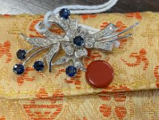 Jewellery: White metal floral spray brooch set with six round cut sapphires, estimated weight of (6)