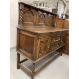 20th cent. Oak buffet with stylised rose decoration to backboard. 60ins. x 53ins. x 22ins.
