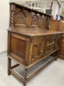 20th cent. Oak buffet with stylised rose decoration to backboard. 60ins. x 53ins. x 22ins.