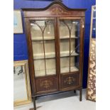 Edwardian mahogany inlaid glazed bookcase on slender supports. 66ins. x 34ins. x 11ins.