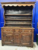 18th cent. Welsh oak dresser with ornate fruit wood frieze to shelves. Base with two long drawers