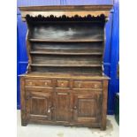 18th cent. Welsh oak dresser with ornate fruit wood frieze to shelves. Base with two long drawers