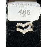 Jewellery: Two individual diamond seven stone wishbone rings. Each ring set with seven round