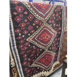 Rugs: 20th cent. Eastern black ground runner with geometric decoration. Approx. 38ins. x 78ins.