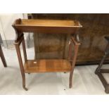 Edwardian mahogany book trolley with acanthus inlay squared supports terminating in brass castors.